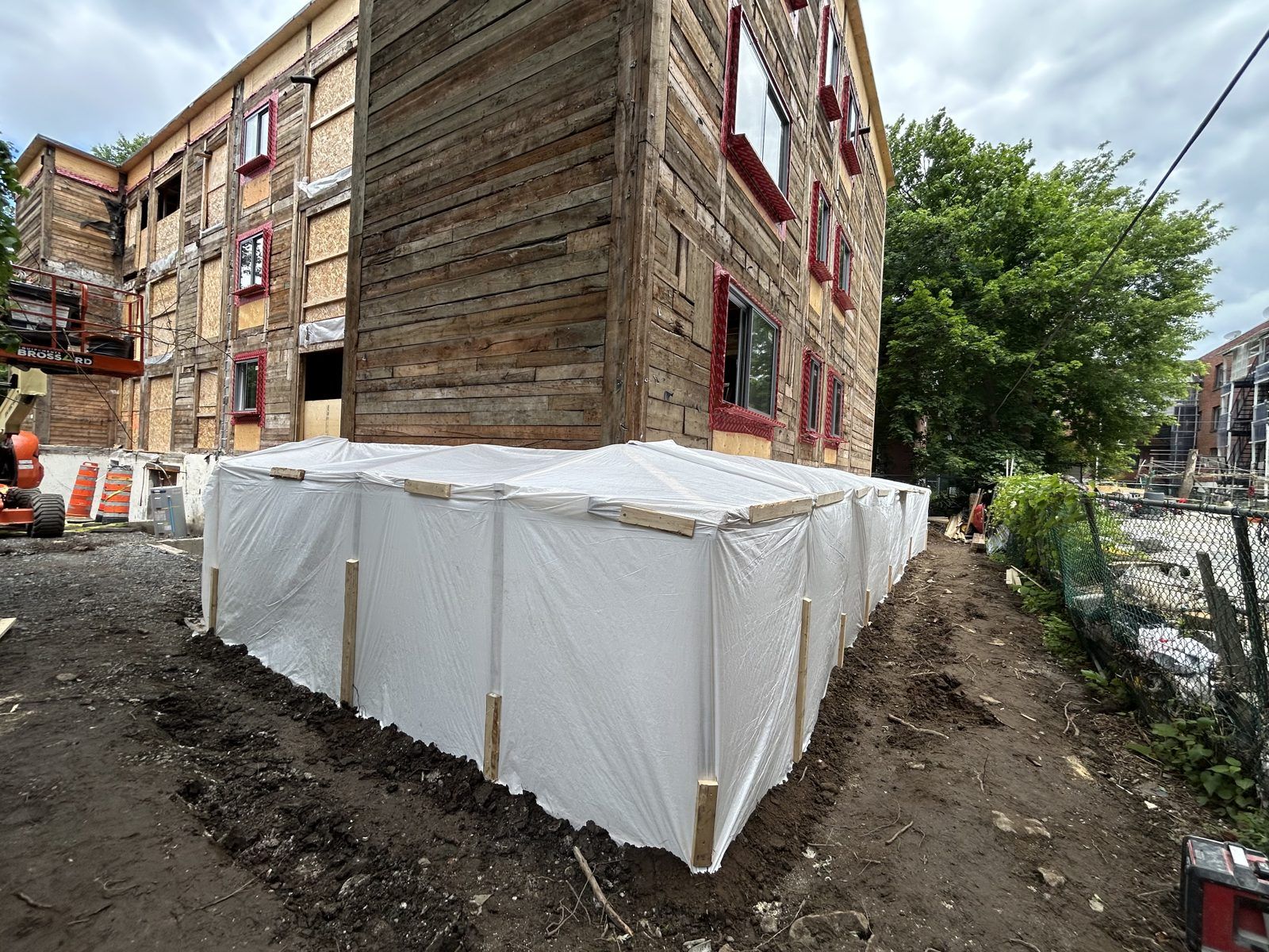 Stripped building with a protective enclosure at ground level